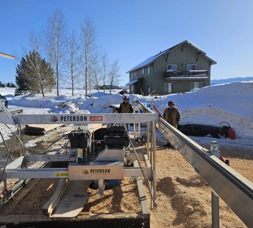 Front view of a 2021 Peterson 10-inch Automated Swingblade Mill set up on track in Wyoming.